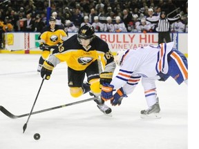 Buffalo Sabres center Tyler Ennis (63) moves around Edmonton Oilers center Mark Arcobello, right, during the first period of an NHL hockey game Friday, Nov. 7, 2014, in Buffalo, N.Y.