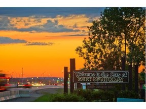 A Welcome to Fort McMurray sign stands on the side of Highway 63 on the south end of Fort McMurray on June 19, 2013.