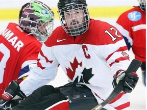 Canada’s Greg Westlake, right, and Norway’s Kjell Christian Hamar compete during their match at the World Sledge Hockey Challenge at Winsport at Canada Olympic Park in Calgary on Dec. 3, 2012.
