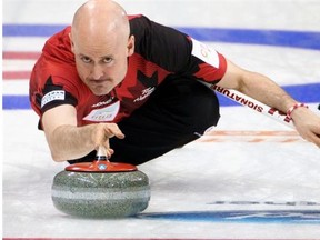 Canada’s Kevin Koe releases the stone against the U.S. for the World Men’s Curling Championship at the Capital Gymnasium in Beijing on April 1, 2014.