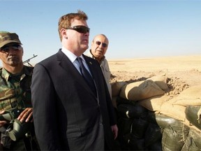 Canadian Foreign Affairs Minister John Baird, centre, and Iraqi Deputy Minister Rowsch Nouri Sharways, right, look at Islamic State positions from a front-line bunker on Sept. 4, 2014 in Kalak, Iraq.