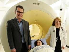 Cardiac patient Valerie Bott, with Dr. Jonathan Abele (left) and Dr. Lucille Lalonde with the combined PET and CT scanners that were recently used to diagnose her along with radiation at the U of A Hospital.