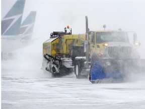 Crews operate snow removal equipment at the Edmonton International Airport on Nov. 27, 2014.