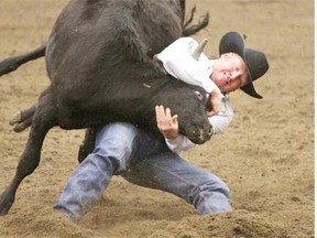 Curtis Cassidy of Donalda, Alta., competes during the steer wrestling event at the Grass Roots Pro Rodeo Finals in Calgary on October 3, 2014.