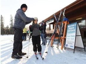 Dario Fogliatti adjusts his son Matteo’s hat during the opening of a winter chalet at Edmonton’s Victoria Golf Course on Dec. 14, 2014. The building, used for cricket in the summer, will now offer rest-stop amenities to skiers, walkers, runners and outdoor adventurers during the winter months.