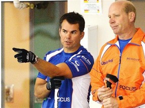David Nedohin, left, discusses strategy with skip Kevin Martin during The Shoot-Out bonspiel at the Saville Community Sports Centre on Sept. 13, 2013.
