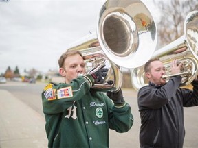 Dennie Hirsch, left, and Matt Laird have been invited to play in the Macy’s Thanksgiving Day Parade in New York. On Sunday, they prepared by practising together in Hirsch’s garage and marching up and down the sidewalk playing the tuba.