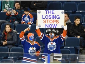 Easton Gladue and his dad Blair Magoo Gladue cheer for the Edmonton Oilers prior to the game against  the San Jose Sharks at Rexall Place in Edmonton.