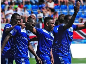 FC Edmonton celebrates a Lance Laing goal against the Carolina RailHawks during a North American Soccer League game at Clarke Field on June 8, 2014. Laing is second from the left.