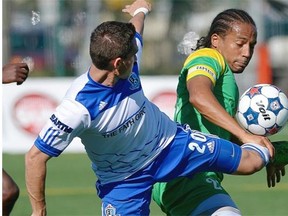 FC Edmonton’s Chad Burt, left, and Tampa Bay Rowdies’ Tamika Mkandawire battle for the ball during North American Soccer League action Sunday, Sept. 21, 2014 at Clarke Field.