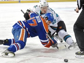 EDMONTON, AB. DECEMBER 7, 2014 -Boyd Gordon (27) of the Edmonton Oilers, wins a draw against Logan Couture of the San Jose Sharks at Rexall Place in Edmonton. Shaughn Butts/Edmonton Journal