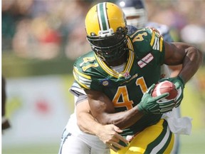 Edmonton Eskimos defensive end Odell Willis runs towards the Toronto Argonauts’ goal-line after tipping a Ricky Ray pass, then catching the ball for an interception in a Canadian Football League game at Commonwealth Stadium on Aug. 23, 2014.