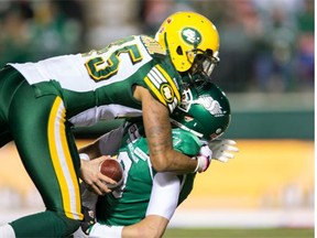 Edmonton Eskimos linebacker Dexter McCoil sacks Saskatchewan Roughriders quarterback Seth Doege in a Canadian Football League game at Mosaic Stadium in Regina on Nov. 8, 2014.