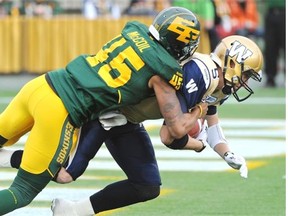 Edmonton Eskimos linebacker Dexter McCoil sacks Winnipeg Blue Bombers quarterback Drew Willy in the end zone for a safety touch during their Canadian Football League game Monday, Oct. 13, 2014, at Edmonton’s Commonwealth Stadium.