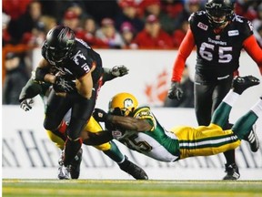 Edmonton Eskimos linebacker Rennie Curran dives in an attempt to tackle Calgary Stampeders running back Jon Cornish during Sunday’s Canadian Football League West Division final at McMahon Stadium in Calgary.