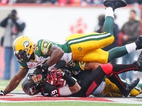 Edmonton Eskimos middle linebacker Rennie Curran tackles Calgary Stampeders kick-returner Sederrik Cunningham during Sunday’s Canadian Football League West Division final against the Calgary Stampeders Nov. 23, 2014. at McMahon Stadium.