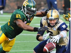 Edmonton Eskimos Odell Willis (41) causes Winnipeg Blue Bombers quarterback Drew Willy (5) to fumble which lead to Eskimos Dexter McCoil (45) running it back for a TD during CFL football action at Commonwealth Stadium in Edmonton on Oct. 13, 2014.