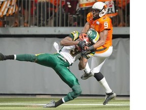 Edmonton Eskimos’ Patrick Watkins, left, prevents B.C. Lions’ Ernest Jackson from making the reception for a touchdown during the second half of a CFL game in Vancouver on Saturday, June 28, 2014.