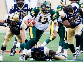 Edmonton Eskimos quarterback Mike Reilly runs for a first down against Winnipeg Blue Bombers during Canadian Football League action at Investors Group Field in Winnipeg, Man., on Thursday, July 17, 2014.