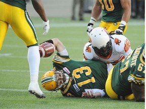 Edmonton Eskimos quarterback Mike Reilly signals that he scored a touchdown after a run to the end zone against the B.C. Lions during Saturday’s Canadian Football League game at Commonwealth Stadium.