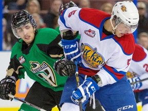 Edmonton Oil Kings Ashton Sautner, right, loses possession of the puck after a stock check from the Raiders Tomas Andrlik in Game 2 of the first playoff series at Rexall Place in Edmonton on Sunday, March 23, 2014. The Edmonton Oil Kings lead the best of seven series 2-0 after winning the game 3-1.