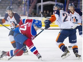 Edmonton Oil Kings defenceman Dysin Mayo gets twisted around by the stick of Kamloops Blazers’ Josh Connolly during the Western Hockey League game at Rexall Place on Oct. 5, 2014.