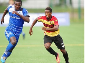 FC Edmonton midfielder Lance Laing races Fort Lauderdale Strikers’ Darryl Gordon to the ball to set up a goal during a North American Soccer League game at Clarke Field on Aug. 24, 2014.