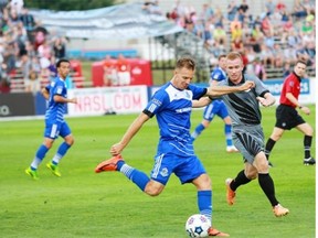 FC Edmonton midfielder Neil Hlavaty makes a play during a North American Soccer League game with the Minnesota United FC on Aug. 9, 2014.