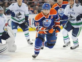 Jordan Eberle of the Edmonton Oilers chases the puck against the Vancouver Canucks at Rexall Place on Friday, Oct. 17, 2014.