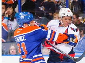 Andrew Ference #21 of the Edmonton Oilers shoves Martin Erat #10 of the Washington Capitals during an NHL game at Rexall Place on October 24, 2013 in Edmonton.