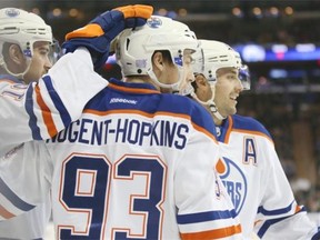 Edmonton Oilers center Ryan Nugent-Hopkins celebrates with his teammates after scoring during the first period of an NHL game against the New York Rangers at Madison Square Garden, Sunday, Nov. 9, 2014, in New York.