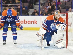 Edmonton Oilers centre Boyd Gordon bows his head as goalie Viktor Fasth looks on following the fifth goal was scored by the Arizona Coyotes at Rexall Place in Edmonton on Dec. 1, 2014. The Oilers lost their 10th game in a row by a score of 5-2.
