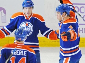 Edmonton Oilers centre Ryan Nugent-Hopkins, top left, celebrates his third period goal with linemates Jordan Eberle, bottom left, and Taylor Hall on Oct. 24, 2014, against the Carolina Hurricanes at Rexall Place in Edmonton.