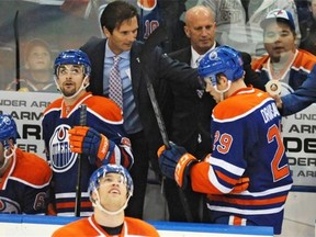 Edmonton Oilers coach Dallas Eakins congratulates forward Leon Draisaitl on his first NHL goal, on Oct. 24 against  the Carolina Hurricanes at Rexall Place.