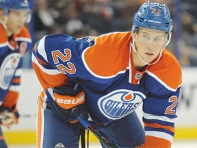 Edmonton Oilers defenceman Keith Aulie lines up for a face-off against the Calgary Flames in pre-season NHL action at Rexall Place in Edmonton on Sunday, Sept. 21, 2014.