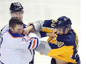 Edmonton Oilers defenseman Keith Aulie (22) takes a punch from Buffalo Sabres right winger Chris Stewart (80) during a fight in the second period of an NHL hockey game Friday, Nov. 7, 2014, in Buffalo, N.Y.