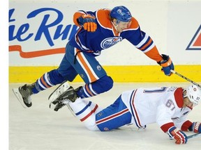 Edmonton Oilers Jeff Petry (left) and Montreal Canadiens Max Pacioretty (right) chase the puck during third period NHL game action in Edmonton on October 27, 2014.