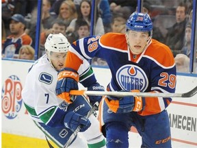 Edmonton Oilers rookie centre Leon Draisaitl is chased behind the net by Linden Vey of the Vancouver Canucks during Saturday’s National Hockey League game at Rexall Place.