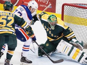 Edmonton Oilers rookie Greg Chase can’t get the puck past Alberta Golden Bears goaltender Kurtis Mucha during the annual rookie game at Clare Drake Arena at the University of Alberta in Edmonton on Tuesday, Sept. 16, 2014.