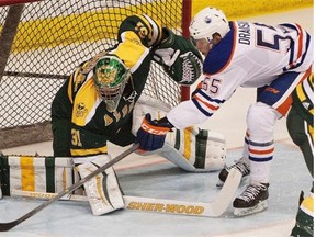 Edmonton Oilers rookie Leon Draisaitl, right, can’t get the puck past Alberta Golden Bears goaltender Kurtis Mucha during pre-season action at Clare Drake Arena at the University of Alberta in Edmonton on Wednesday, Sept. 17, 2014.