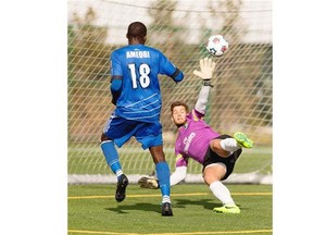 FC Edmonton’s Tomi Ameobi scores the tying goal on New York Cosmos goalkeeper Jimmy Maurer during North American Soccer League game at Clarke Field on Sunday, Sept. 28, 2014.