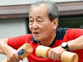 An elderly man works out with wooden dumbbells on the grounds of a Tokyo temple on Sept. 15 to celebrate Japan’s Respect-for-the-Aged-Day. The number of people aged 65 or older in Japan is at a record 32.96 million, accounting for an all-time high of 25.9 per cent of the nation’s total population, the government announced.