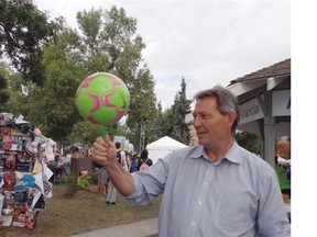 Alberta Tourism Minister Richard Starke gets a lesson in juggling from performer Victor Rubilar during a news conference announcing a $35,000 grant to the Edmonton Fringe Festival and two other Alberta events.