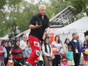 Sean Bridges, the amazing bike boy, looks a knife he’s juggling, while balancing on a moving bike, right in the eye at the 2014 Edmonton Fringe Festival.