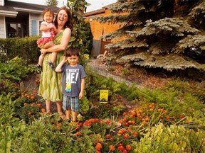 Erin Lau, with her son Marcus, 4, and daughter Norah, 2, in her front yard vegetable garden