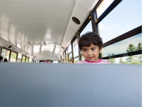 Eshal Rizwan ,1, sits with her mother Shumailia Rizwan (not visible in Picture) as they take part in the 9th annual First Riders, an educational program for new school bus riders on August 27, 2014 in Edmonton.  Edmonton Public Schools, Edmonton Catholic Schools and Conseil scolaire Centre-Nord, along with five school bus contractors and EdmontonTransit (ETS), are hosting the event.
