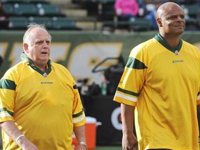 Former Edmonton Eskimos quarterbacks, alumni Tom Wilkinson, left, and Warren Moon, were on hand at the special halftime ceremony where Hector Pothier and Bill Stevenson had their names added to the Eskimo Wall of Honour during CFL football action at Commonwealth Stadium in Edmonton, Oct. 13, 2014.