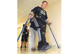 Four years after a motor vehicle accident that stole his mobility below his chest, wheelchair bound Denny Ross uses a ReWalk Robotics exoskeleton, which provides powered hip and knee motion for people with paraplegia to walk again, at the University of Alberta on Tuesday, Sept. 16, 2014.