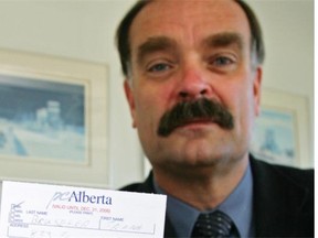 Frank Bruseker, a former Liberal MLA and former head of the Alberta Teachers’ Association, holds a Progressive Conservative membership card in this 2006 file photo.