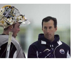 New Edmonton Oilers goaltenders coach Frederic Chabot, right, talks to goalie Olivier Roy on Day 1 of the team's development camp at Millennium Place in Sherwood Park on Monday.